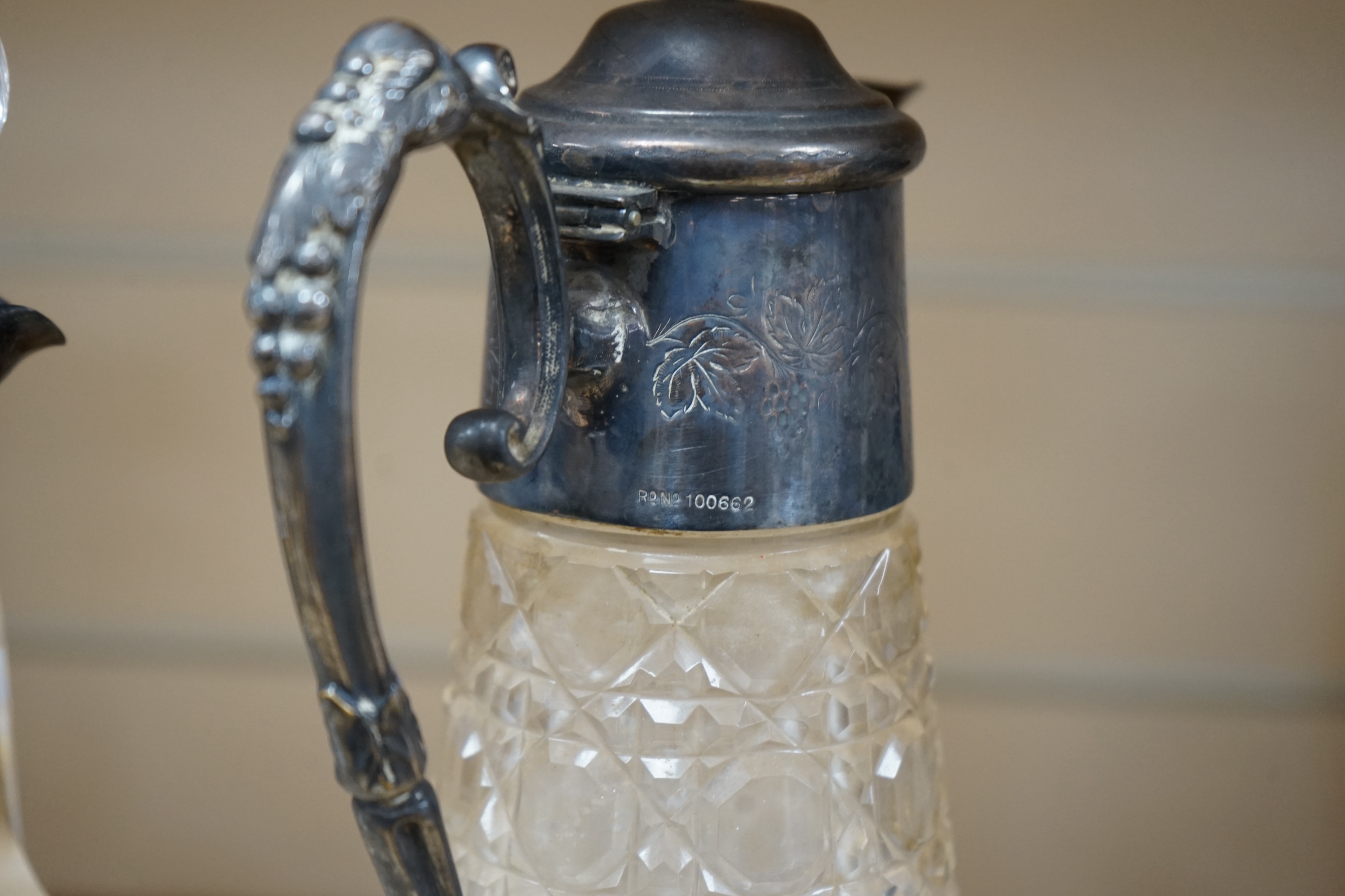 An Edwardian silver mounted cut glass decanter and stopper, London, 1901, height 26cm, together with a silver plate mounted cut glass claret jug. Condition - poor to fair